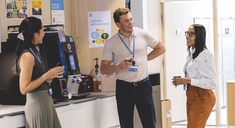 Three Yara colleagues chatting by coffee machine